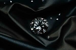 luxe diamant sur une noir en tissu Contexte. coûteux bijoux photo