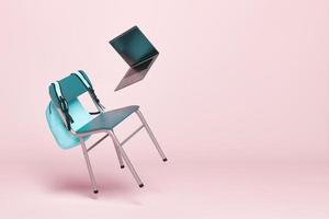 chaise d'école et ordinateur portable flottant dans les airs photo