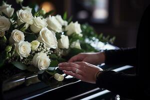 fermer de une femme main placement une bouquet de blanc des roses dans une cercueil.funérailles concept ai généré photo