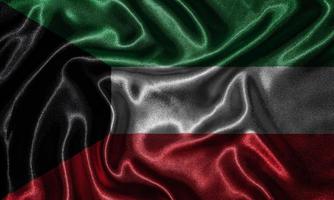 papier peint par drapeau du Koweït et drapeau ondulant par tissu. photo