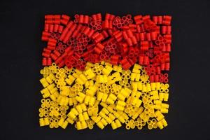 briques en plastique jaune et rouge sur fond noir photo