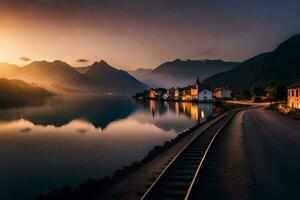 une train des pistes court le long de le côté de une Lac à le coucher du soleil. généré par ai photo