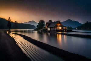 une maison est assis sur le rive de une Lac à le coucher du soleil. généré par ai photo