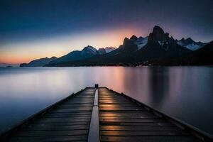 une jetée dans le milieu de une Lac à le coucher du soleil. généré par ai photo