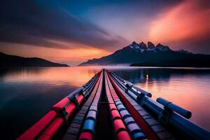 une longue ligne de rouge tuyaux sur le l'eau à le coucher du soleil. généré par ai photo