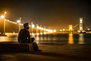 une homme séance sur le plage à nuit avec le d'or porte pont dans le Contexte. généré par ai photo