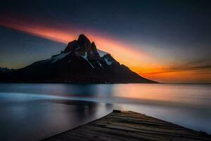 une jetée à le coucher du soleil avec montagnes dans le Contexte. généré par ai photo