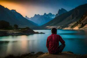 une homme séance sur le bord de une Lac à le coucher du soleil. généré par ai photo