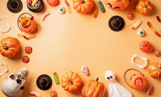 décorations de vacances d'halloween avec vue de dessus de citrouilles et de bonbons photo