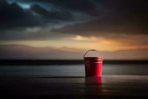 une rouge seau est assis sur le plage à le coucher du soleil. généré par ai photo