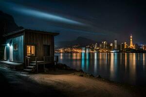 une petit cabine est assis sur le rive de une Lac à nuit. généré par ai photo