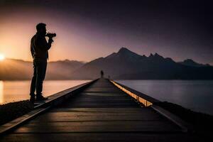 une homme prise une photo de le le coucher du soleil sur une jetée. généré par ai