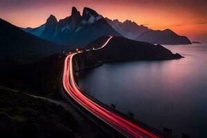 une longue exposition photographier de une route et montagnes à le coucher du soleil. généré par ai photo