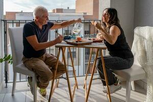 magnifique milieu vieilli couple en mangeant chinois prendre une façon nourriture séance à une posé table photo