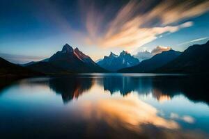 le montagnes sont réfléchi dans le l'eau à le coucher du soleil. généré par ai photo