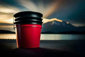 une rouge seau séance sur le sol près une lac. généré par ai photo