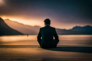 une homme dans une costume est assis sur le plage à le coucher du soleil. généré par ai photo