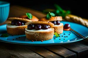 petit Gâteaux avec cerises sur une bleu plaque. généré par ai photo