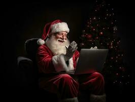 ai généré ai génération. Père Noël claus en utilisant une portable ordinateur. séance dans une chaise sur le veille de photo