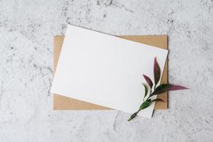 une carte vierge avec enveloppe et fleur est placée sur fond blanc photo