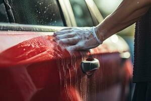 homme la lessive rouge voiture avec savon, fermer de mains, gens main proche en haut nettoyage voiture avec une éponge à le voiture laver, ai généré photo