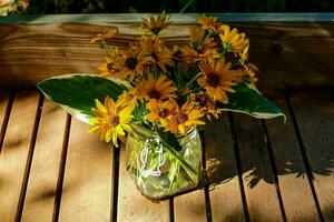 une verre avec Jaune fleurs photo