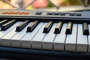 fermer de piano clés. piano noir et blanc clés et piano clavier musical instrument mis à le Accueil balcon pendant ensoleillé journée. photo