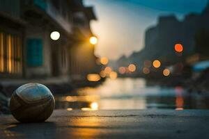 une football Balle est assis sur le sol dans de face de une rivière. généré par ai photo