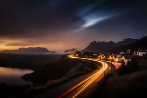 une longue exposition photographier de une route et Montagne à nuit. généré par ai photo