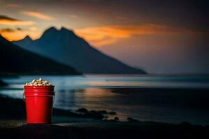 une rouge seau avec pop corn sur le plage à le coucher du soleil. généré par ai photo