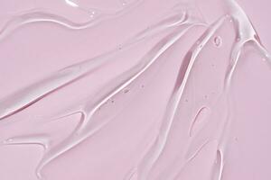texture de visage sérum. abstrait Contexte de hydratant transparent gel sur rose Contexte photo