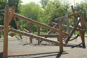 en bois terrain de jeux fabriqué de Naturel respectueux de la nature Matériel dans Publique ville parc. moderne sécurité les enfants Extérieur équipement. concept de durable mode de vie et écologie. les enfants du repos et Jeux sur ouvert air photo