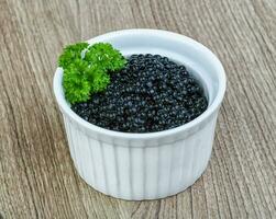 caviar noir sur fond de bois photo