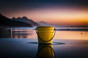 une Jaune seau est assis sur le plage à le coucher du soleil. généré par ai photo