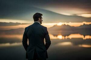 une homme dans une costume des stands dans de face de une Lac à le coucher du soleil. généré par ai photo