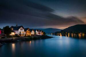 Maisons sur le rive de une Lac à nuit. généré par ai photo