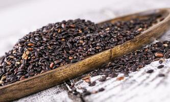 proche en haut de noir riz sur en bois surface photo