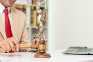 du juge marteau dans loi Bureau est mis sur table à symboliser juge décider procès. marteau bois sur en bois table de avocats dans légal Conseil Bureau comme symbole de juste jugement dans cas. photo