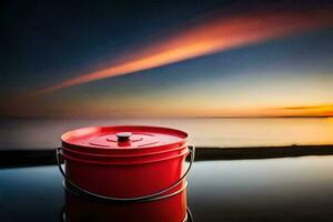 une rouge seau séance sur le bord de une Lac à le coucher du soleil. généré par ai photo