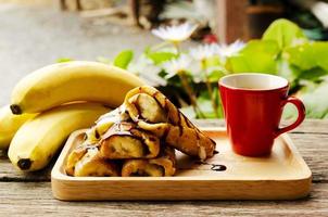 gros plan de pain perdu avec des bananes et des tasses à café rouge photo