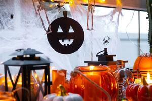 de fête décor de le maison sur le rebord de fenêtre pour Halloween - citrouilles, jack o lanternes, crânes, toiles d'araignées, araignées, squelettes, bougies et une guirlande - une confortable et terrible ambiance photo