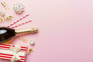 bouteille de Champagne avec coloré briller, confettis et cadeau boîte espace pour texte sur coloré arrière-plan, Haut voir. hilarant, Noël et anniversaire fête photo