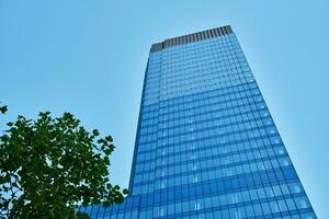 moderne ville architecture, gratte-ciel verre façade avec vert arbre photo