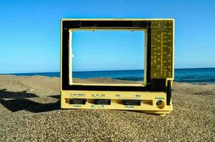 une petit vieux télévision sur une plage photo