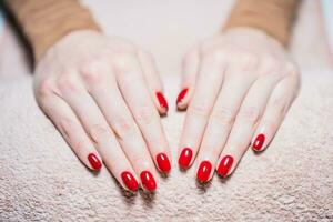 proche en haut image de femme mains avec rouge peint les ongles. manucure concept ,se concentrer sur clous. photo