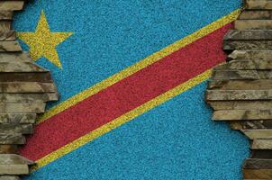 démocratique république de le Congo drapeau représenté dans peindre couleurs sur vieux pierre mur fermer. texturé bannière sur Roche mur Contexte photo