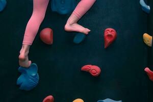 une enfant grimpe une escalade mur photo