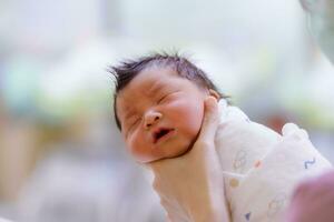 le bébé garçon a été juste née avec bébé tissu enveloppé autour le entier corps photo
