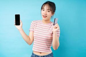 portrait de jeune fille, téléphone et carte de guichet automatique à la main
