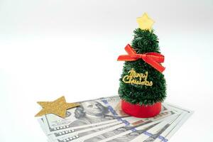peu Noël arbre et or étoile avec argent, dollars. isolé sur blanc Contexte. Noël Contexte. photo